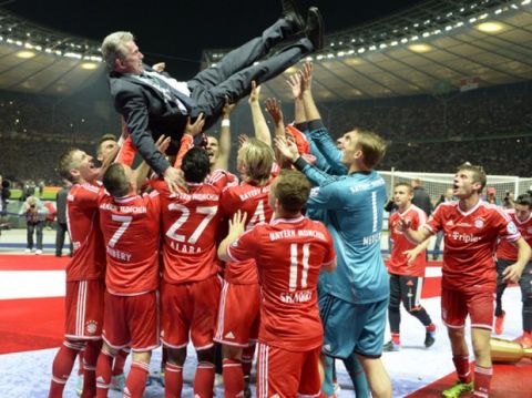 Bayern Munich's head coach Jupp Heynckes (up) is thrown in the air by his players after they won the final football match of the German Cup (DFB - Pokal) FC Bayern Munich vs VfB Stuttgart on June 1, 2013 at the Olympic Stadium in Berlin. Champions League winners Bayern Munich became the first Bundesliga champion to win the treble after their hard-earned 3-2 win over plucky VfB Stuttgart in Saturday's German Cup final.
AFP PHOTO / CHRISTOF STACHE

RESTRICTIONS / EMBARGO - DFL LIMITS THE USE OF IMAGES ON THE INTERNET TO 15 PICTURES (NO VIDEO-LIKE SEQUENCES) DURING THE MATCH AND PROHIBITS MOBILE (MMS) USE DURING AND FOR FURTHER TWO HOURS AFTER THE MATCH. FOR MORE INFORMATION CONTACT DFL        (Photo credit should read CHRISTOF STACHE/AFP/Getty Images)