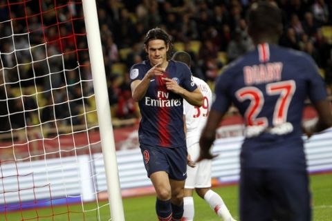 PSG's Edinson Cavani, center, celebrates with teammate Moussa Diaby after scoring his third goal of the game, during the French League One soccer match between AS Monaco and Paris Saint-Germain at Stade Louis II in Monaco, Sunday, Nov. 11, 2018 (AP Photo/Claude Paris)