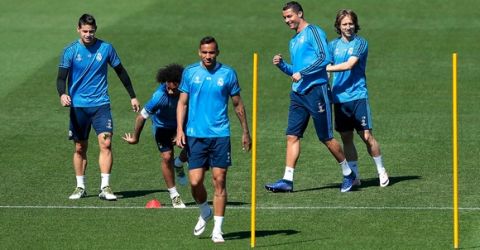 "MADRID, SPAIN - MAY 03:  Luka Modric of Real Madrid (r) jokes with Cristiano Ronaldo of Real Madrid during a training session ahead of the UEFA Champions League Semi Final Second Leg between Real Madrid and Manchester City at Valdebebas training ground on May 3, 2016 in Madrid, Spain.  (Photo by Gonzalo Arroyo Moreno/Getty Images)"