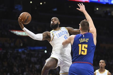 Los Angeles Lakers forward LeBron James (6) goes to the basket against Denver Nuggets center Nikola Jokic (15) during the first half of an NBA basketball game Sunday, Oct. 30, 2022, in Los Angeles. (AP Photo/Michael Owen Baker)