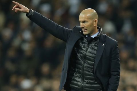 Real Madrid coach Zinedine Zidane gives instructions to his players during the Champions League soccer match, round of 16, 1st leg between Real Madrid and Paris Saint Germain at the Santiago Bernabeu stadium in Madrid, Spain, Wednesday, Feb. 14, 2018. (AP Photo/Paul White)