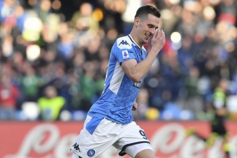 Napoli's Arkadiusz Milik celebrates after scoring his side's first goal during the Italian Serie A soccer match between Napoli and Lecce at the San Paolo stadium in Naples, Italy, Sunday, Feb. 9, 2020. (Cafaro/LaPresse via AP)