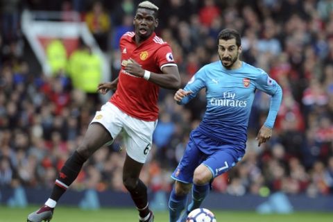 Arsenal's Henrikh Mkhitaryan, right, and Manchester United's Paul Pogba run for the ball during the English Premier League soccer match between Manchester United and Arsenal at the Old Trafford stadium in Manchester, England, Sunday, April 29, 2018. (AP Photo/Rui Vieira)