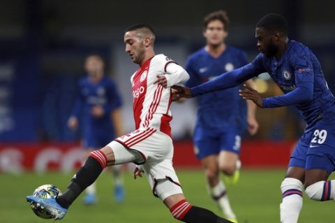 Ajax's Hakim Ziyech, left, duels for the ball with Chelsea's Fikayo Tomori during the Champions League, group H, soccer match between Chelsea and Ajax, at Stamford Bridge in London, Tuesday, Nov. 5, 2019. (AP Photo/Ian Walton)