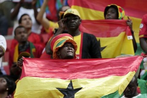 Fans of Ghana listen to the national anthem before the group G World Cup soccer match between Portugal and Ghana at the Estadio Nacional in Brasilia, Brazil, Thursday, June 26, 2014. (AP Photo/Marcio Jose Sanchez) Brazil Soccer WCup Portugal Ghana