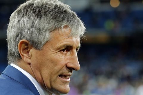 FILE _ In this Wednesday, March 1, 2017 file photo, Las Palmas coach Quique Setien waits for the start of a Spanish La Liga soccer match between Real Madrid and Las Palmas at the Santiago Bernabeu stadium in Madrid, Spain. The Spanish league only has four games remaining, but there are some coaches who may not make it that far. Real Betis manager Quique Setien and Gironas Eusebio Sacristan are under pressure after losing streaks, while Alaves coach Abelardo Fernandez has had a falling out with his club over his future.  (AP Photo/Paul White, File)