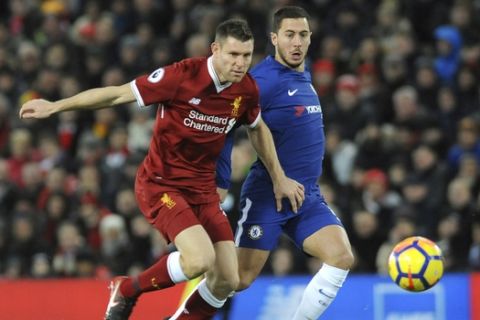 Liverpool's James Milner, left, and Chelsea's Eden Hazard battle for the ball during the English Premier League soccer match between Liverpool and Chelsea at Anfield, Liverpool, England, Saturday, Nov. 25, 2017. (AP Photo/Rui Vieira)