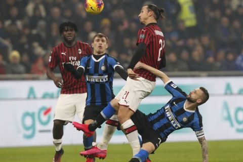 AC Milan's Zlatan Ibrahimovic vies for the ball with Inter Milan's Marcelo Brozovic during the Serie A soccer match between Inter Milan and AC Milan at the San Siro Stadium, in Milan, Italy, Sunday, Feb. 9, 2020. (AP Photo/Antonio Calanni)