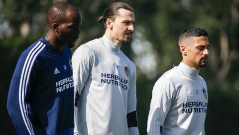 LA Galaxy's newest player Zlatan Ibrahimovic,center, of Sweden, warms up during an MLS soccer training session at the StubHub Center, Friday, March 30, 2018, in Carson, Calif. (AP Photo/Ringo H.W. Chiu)