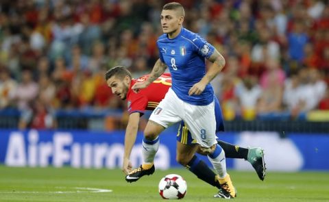 Italy's Marco Verratti runs with the ball away from Spain's Koke, left, during the World Cup Group G qualifying soccer match between Spain and Italy at the Santiago Bernabeu Stadium in Madrid, Saturday Sept. 1, 2017. (AP Photo/Paul White)