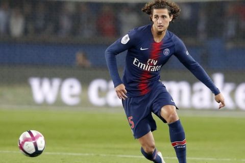In this Sept. 26, 2018, photo, PSG's Adrien Rabiot controls the ball during the French League One soccer match between Paris-Saint-Germain and Reims at Parc des Princes stadium in Paris, France. New Juventus midfielder Adrien Rabiot says club great Gianluigi Buffon "was persuasive" in his decision to sign with the Italian champion. Rabiot says Buffon, his teammate at Paris Saint-Germain last season, was "the best person I could talk to. His opinion matters a lot to me." The 24-year-old Frenchman spoke at a news conference on Tuesday to complete a free transfer move. He ran down his contract in a troubled last season in Paris. (AP Photo/Michel Euler)