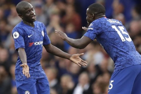 Chelsea's N'Golo Kante, left, celebrates with Chelsea's Kurt Zouma after scoring his side's opening goal during the British premier League soccer match between Chelsea and Liverpool, at the Stamford Bridge Stadium, London, Sunday, Sept. 22, 2019. (AP Photo/Matt Dunham)