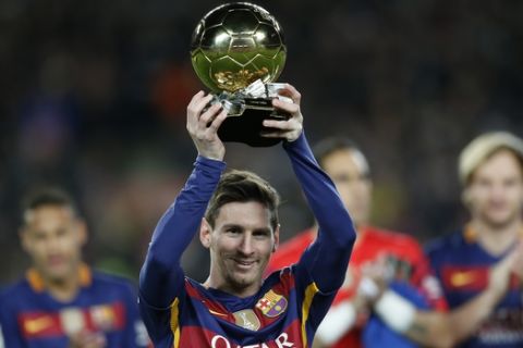 FC Barcelona's Lionel Messi, from Argentina, holds up his Ballon d'Or (Golden Ball) award as European Footballer of the Year prior the Spanish La Liga soccer match between FC Barcelona and Athletic Bilbao at the Camp Nou stadium in Barcelona, Spain, Sunday, Jan. 17, 2016. (AP Photo/Manu Fernandez)
