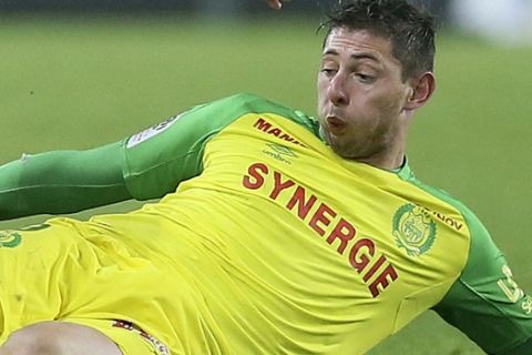 FILE - In this Sunday, Jan. 14, 2018 file photo Nantes' forward Emiliano Sala makes a tackle during a French League One soccer match, in Nantes, western France. The French civil aviation authority said Tuesday Jan. 22, 2019, Argentine soccer player Emiliano Sala was aboard a small passenger plane that went missing off the coast of the island of Guernsey. French and British maritime authorities are searching the English Channel for the plane. (AP Photo/David Vincent, File)