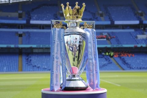 The Premier League trophy for Manchester City sits on the pitch prior to the English Premier League soccer match between Manchester City and Huddersfield Town at Etihad stadium in Manchester, England, Sunday, May 6, 2018. (AP Photo/Rui Vieira)