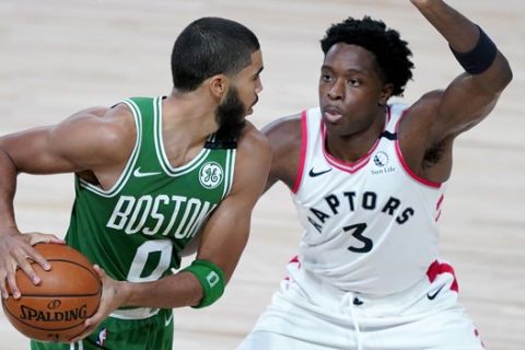 Boston Celtics' Jayson Tatum (0) works against Toronto Raptors' OG Anunoby (3) during the second half of an NBA basketball game Friday, Aug. 7, 2020 in Lake Buena Vista, Fla. (AP Photo/Ashley Landis, Pool)