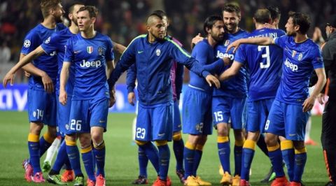 Juventus' teammates celebrate after qualifying for the semifinals of the UEFA Champions League following the quarter final second leg football match AS Monaco vs Juventus FC on April 22, 2015 at the Louis II Stadium in Monaco.  AFP PHOTO / PASCAL GUYOT        (Photo credit should read PASCAL GUYOT/AFP/Getty Images)