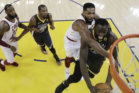Golden State Warriors' Draymond Green, bottom, right, works for a rebound against Cleveland Cavaliers' Tristan Thompson, second from right, during the second half of Game 2 of basketball's NBA Finals Sunday, June 3, 2018, in Oakland, Calif. (AP Photo/Marcio Jose Sanchez, Pool)
