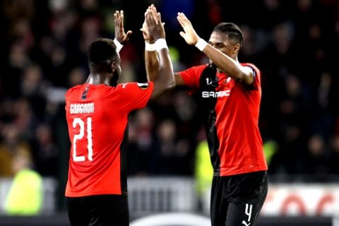 Rennes' Joris Gnagnon, left, and Rennes' Gerzino Nyamsi celebrate at the end of the the Europa League Group E soccer match between Rennes and Lazio, at the Roazhon Park stadium in Rennes, France, Thursday, Dec. 12, 2019. Rennes won 2-0. (AP Photo/David Vincent)