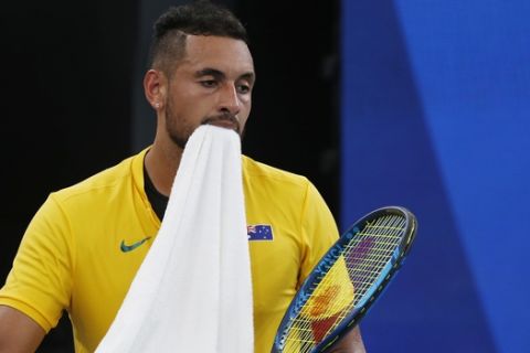 Nick Kyrgios of Australia walks onto a court against Cameron Norrie of Britain during their ATP Cup tennis match in Sydney, Thursday, Jan. 9, 2020. (AP Photo/Steve Christo)