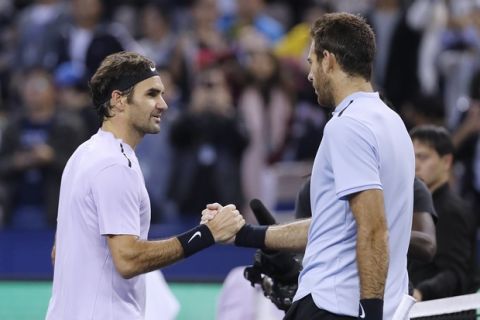 Roger Federer of Switzerland, left, shakes hands with his opponent Juan Martin del Potro of Argentina after winning their men's semifinals match of the Shanghai Masters tennis tournament at Qizhong Forest Sports City Tennis Center in Shanghai, China, Saturday, Oct. 14, 2017. (AP Photo/Andy Wong)