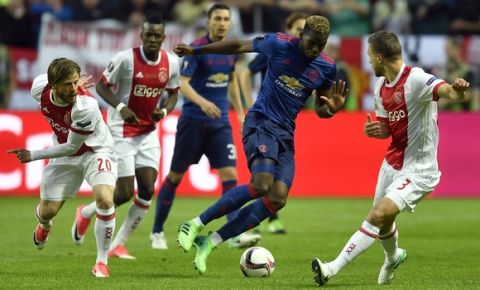 United's Paul Pogba challenges Ajax's Joel Veltman, right, during the soccer Europa League final between Ajax Amsterdam and Manchester United at the Friends Arena in Stockholm, Sweden, Wednesday, May 24, 2017. (AP Photo/Martin Meissner)