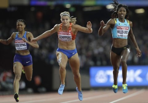Netherlands' Dafne Schippers, center, dips to win the gold in the Women's 200m final during the World Athletics Championships in London Friday, Aug. 11, 2017. (AP Photo/David J. Phillip)