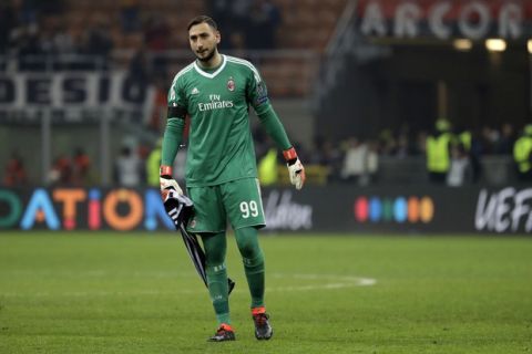 AC Milan goalkeeper Gianluigi Donnarumma walks on the pitch at the end of the Europa League round of 16 first-leg soccer match between AC Milan and Arsenal, at the Milan San Siro Stadium, Italy, Thursday, March 8, 2018. The match finished 0-2. (AP Photo/Luca Bruno)
