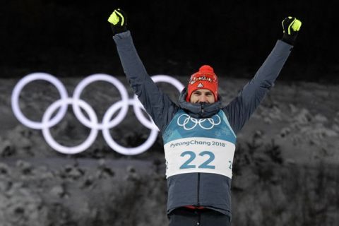 Arnd Peiffer, of Germany, celebrates his gold medal during the venue ceremony after the men's 10-kilometer biathlon sprint at the 2018 Winter Olympics in Pyeongchang, South Korea, Sunday, Feb. 11, 2018. (AP Photo/Gregorio Borgia)