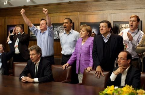 Prime Minister David Cameron of Britain (centre L-R) , President Barack Obama, Chancellor Angela Merkel of Germany, Jose Manuel Barroso, President of the European Commission, and others watch the overtime shootout of the Chelsea vs. Bayern Munich Champions League final in the Laurel Cabin conference room during the G8 Summit at Camp David, Maryland, May 19, 2012.  REUTERS/White House/ Pete Souza/POOL  (UNITED STATES - Tags: POLITICS SPORT SOCCER TPX IMAGES OF THE DAY)