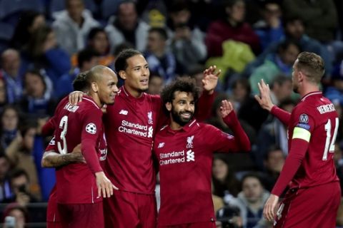 Liverpool's Virgil van Dijk celebrates with teammates after scoring his side's fourth goal during the Champions League quarterfinals, 2nd leg, soccer match between FC Porto and Liverpool at the Dragao stadium in Porto, Portugal, Wednesday, April 17, 2019. (AP Photo/Luis Vieira)