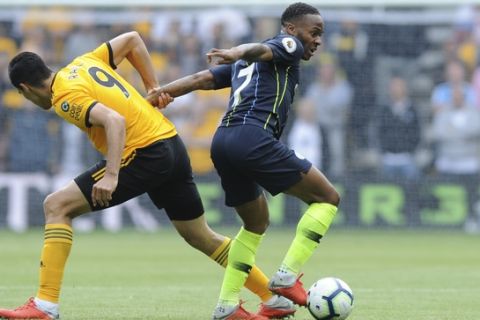 Wolverhampton Wanderers' Raul Jimenez vies for the ball with Manchester City's Raheem Sterling, right, during the English Premier League soccer match between Wolverhampton Wanderers and Manchester City at the Molineux Stadium in Wolverhampton, England, Saturday, Aug. 25, 2018. (AP Photo/Rui Vieira)