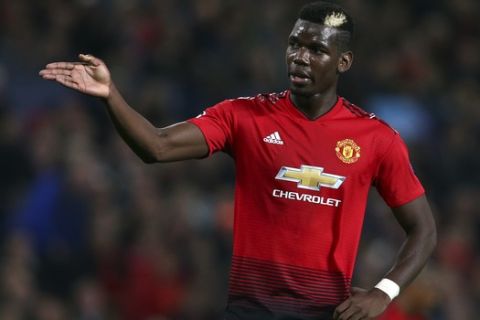 ManU midfielder Paul Pogba reacts after missing a chance to score during the Champions League group H soccer match between Manchester United and Juventus at Old Trafford, Manchester, England, Tuesday, Oct. 23, 2018. (AP Photo/Dave Thompson)