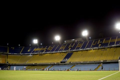 Boca Juniors plays against Racing Club in an empty Bombonera stadium during a Copa Libertadores soccer match in Buenos Aires, Argentina, Thursday, March 3, 2016. The game is played in the empty closed door stadium because of the violent incidents in 2015 when fans used pepper spray against River Plate players. (AP Photo/Natacha Pisarenko)