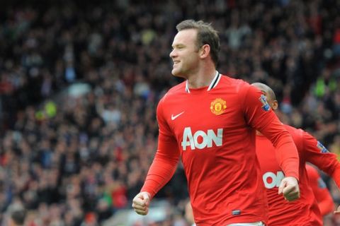 Manchester United's English forward Wayne Rooney (L) is congratulated after scoring a penalty during the English Premier League football match between Manchester United and Aston Villa at Old Trafford in Manchester, north-west England, on April 15, 2012. AFP PHOTO/ANDREW YATES
 RESTRICTED TO EDITORIAL USE. No use with unauthorized audio, video, data, fixture lists, club/league logos or live services. Online in-match use limited to 45 images, no video emulation. No use in betting, games or single club/league/player publications