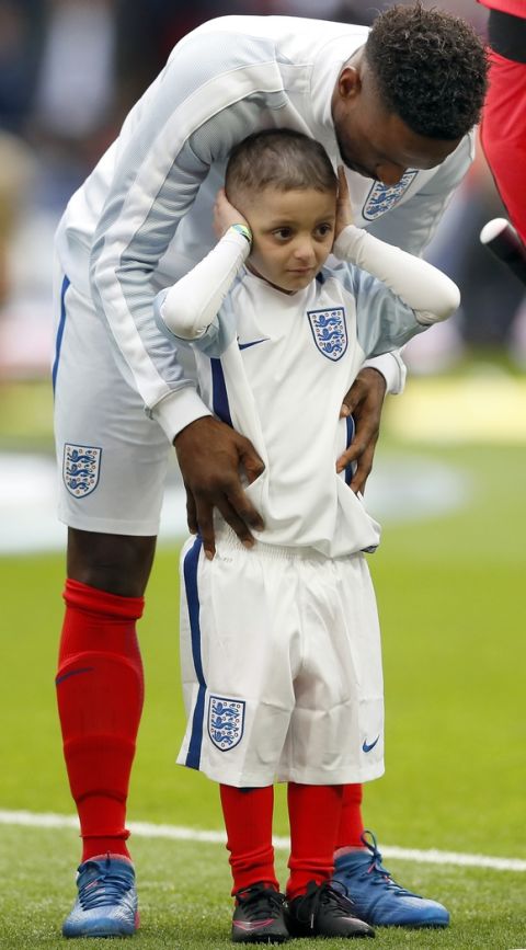 Bradley Lowery, front, and England's Jermain Defoe attend the national anthems prior to the World Cup Group F qualifying soccer match between England and Lithuania at the Wembley Stadium in London, Great Britain, Sunday, March 26, 2017. Bradley Lowery is battling a rare form of cancer and is set to lead England out onto the pitch at Wembley on March 26. (AP Photo/Kirsty Wigglesworth)