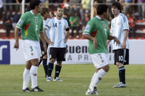 Argentina's Javier Mascherano (14), and Lionel Messi (10)  react as Bolivia's Luis Gatty Ribeiro (7) and Walter Flores celebrate at the end of a 2010 World Cup qualifying soccer match against Bolivia in La Paz, Wednesday, April 1, 2009. Bolivia won 6-1.  (AP Photo/Martin Mejia)