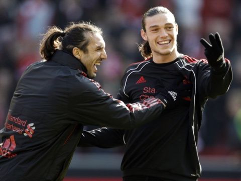 Liverpool's Sotirios Kyrgiakos (L) jokes with Andy Carroll before their English Premier League soccer match against Manchester United at Anfield in Liverpool, northern England, March 6, 2011.   REUTERS/Phil Noble   (BRITAIN - Tags: SPORT SOCCER) NO ONLINE/INTERNET USAGE WITHOUT A LICENCE FROM THE FOOTBALL DATA CO LTD. FOR LICENCE ENQUIRIES PLEASE TELEPHONE ++44 (0) 207 864 9000