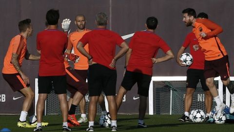 FC Barcelona's Lionel Messi, center right, heads the ball during training session at the Sports Center FC Barcelona Joan Gamper in Sant Joan Despi, Spain, Tuesday, Oct. 17, 2017. FC Barcelona will play against Olympiacos in a Champions League Group D soccer match on Wednesday. (AP Photo/Manu Fernandez)