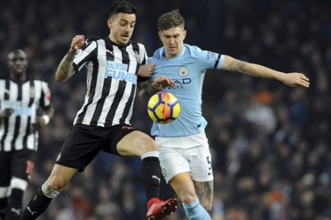 Newcastle's Joselu fights for the ball with Manchester City's John Stones, right, during the English Premier League soccer match between Manchester City and Newcastle United at the Etihad Stadium in Manchester, England, Saturday, Jan. 20, 2018. (AP Photo/Rui Vieira)