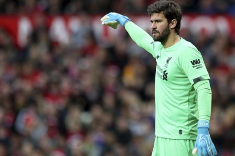 Liverpool's goalkeeper Alisson reacts during the English Premier League soccer match between Manchester United and Liverpool at the Old Trafford stadium in Manchester, England, Sunday, Oct. 20, 2019. (AP Photo/Jon Super)