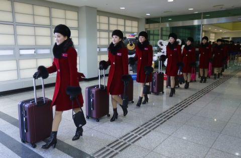 North Korean cheering squads arrive at the Korean-transit office near the Demilitarized Zone in Paju, South Korea, Wednesday, Feb. 7, 2018. A North Korean delegation, including members of a state-trained cheering group, arrived in South Korea on Wednesday for the Pyeongchang Winter Olympics. (AP Photo/Ahn Young-joon. Pool)