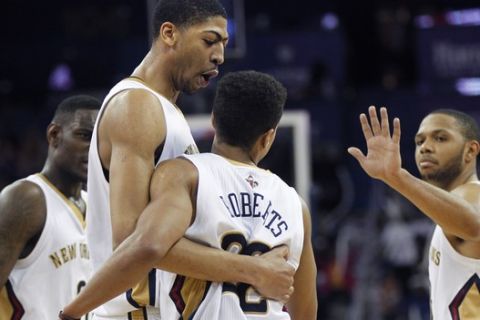 New Orleans Pelicans point guard Brian Roberts (22) is congratulated by power forward Anthony Davis, center, shooting guard Eric Gordon, right, and shooting guard Anthony Morrow, left, after scoring a key basket in the final moments of the second half of an NBA basketball game against the Atlanta Hawks in New Orleans, Wednesday, Feb. 5, 2014. The Pelicans won 105-100.  (AP Photo/Gerald Herbert)