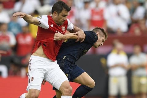 Arsenal defender Sokratis, left, battles for the ball against Real Madrid midfielder Toni Kroos (8) during the first half of an International Champions Cup soccer match, Tuesday, July 23, 2019, in Landover, Md. (AP Photo/Nick Wass)