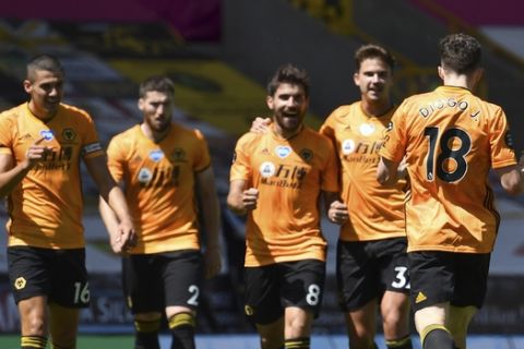 Wolverhampton Wanderers' Diogo Jota, front right, celebrates with teammates after scoring his side's third goal during the English Premier League soccer match between Watford and Everton at the Molineux Stadium in Wolverhampton, England, Sunday, July 12, 2020. (Ben Stansall/Pool via AP)
