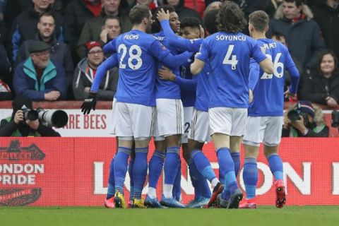 Leicester's players celebrate their side's first goal, scored by Kelechi Iheanacho, during the English FA Cup fourth round soccer match between Brentford FC and Leicester City at Griffin Park stadium in London, Saturday, Jan. 25, 2020. (AP Photo/Kirsty Wigglesworth)