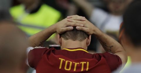 Roma's Francesco Totti gets emotional as he salutes his fans after an Italian Serie A soccer match between Roma and Genoa at the Olympic stadium in Rome, Sunday, May 28, 2017. Francesco Totti is playing his final match with Roma against Genoa after a 25-season career with his hometown club. (AP Photo/Alessandra Tarantino)