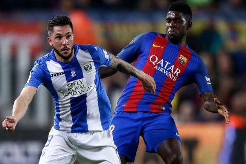 FC Barcelona's Samuel Umtiti, right, duels for the ball against Leganes' Miguel Angel Guerrero during the Spanish La Liga soccer match between FC Barcelona and Leganes at the Camp Nou stadium in Barcelona, Spain, Sunday, Feb. 19, 2017. (AP Photo/Manu Fernandez)