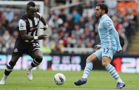 Manchester City's Carlos Tevez, right, vies for the ball with Newcastle United's Cheick Tiote, left, during their English Premier League soccer match at the Sports Direct Arena, Newcastle, England, Sunday, May 6, 2012. (AP Photo/Scott Heppell)