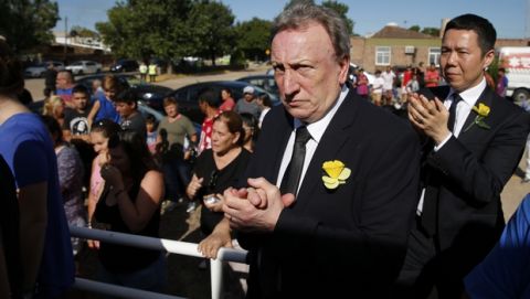 Cardiff City manager Neil Warnock, second righ, and Cardiff City CEO Ken Choo, right, applaud during the burial of Emiliana Sala, at the cementary in Santa Fe, Argentina, Saturday, Feb. 16, 2019. The Argentina-born forward died in an airplane crash in the English Channel last month when flying from Nantes in France to start his new career with English Premier League club Cardiff. (AP Photo/Natacha Pisarenko)